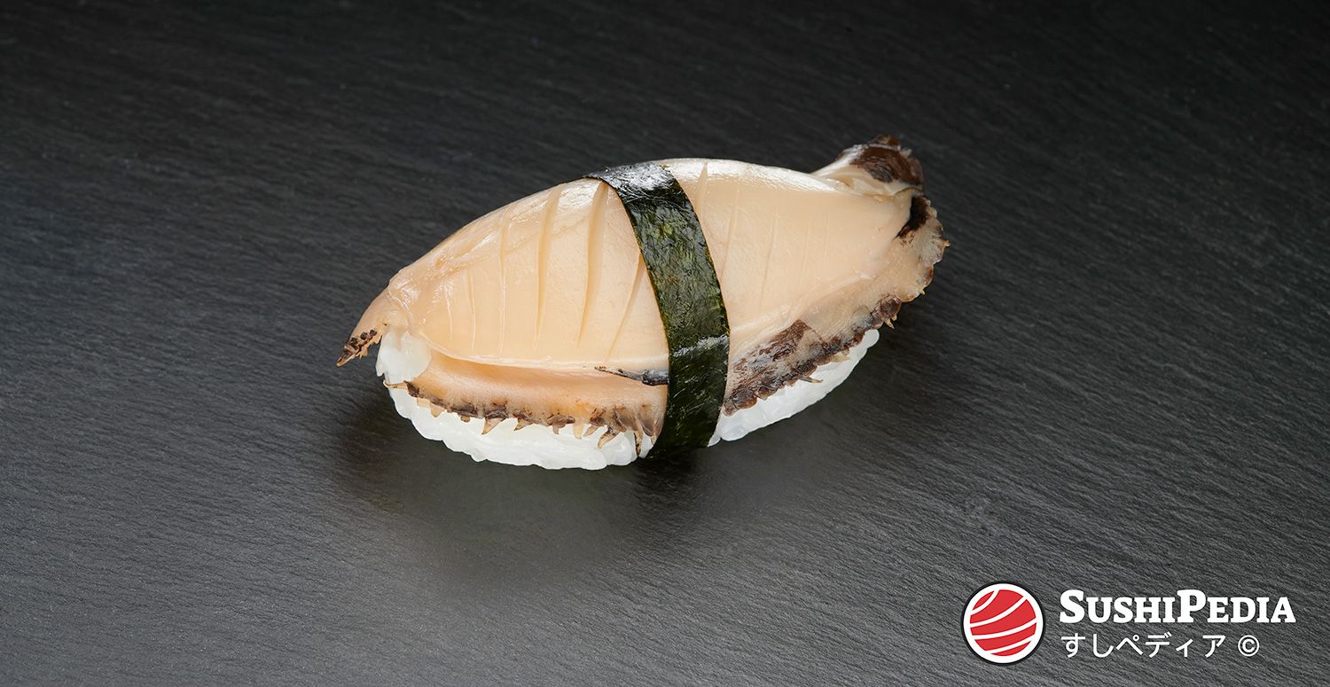 Ein frisch zubereitetes Nigiri-Sushi (Palmen-Sushi) mit der Hauptzutat, auf Japanisch "awabi" genannt, ruht auf einer Steinplatte.