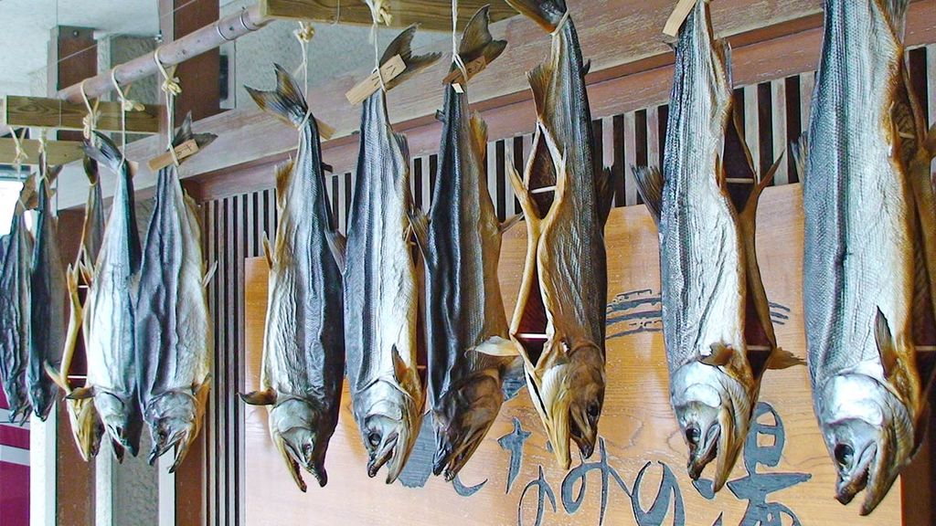 Getrockneter Lachs, typisch für die Stadt Murakami, aufgehängt an Bambusstangen.