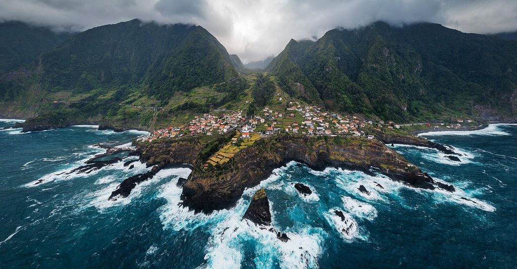 Seixal village as seen from air above the ocean in Porto Moniz, Madeira, Portugal