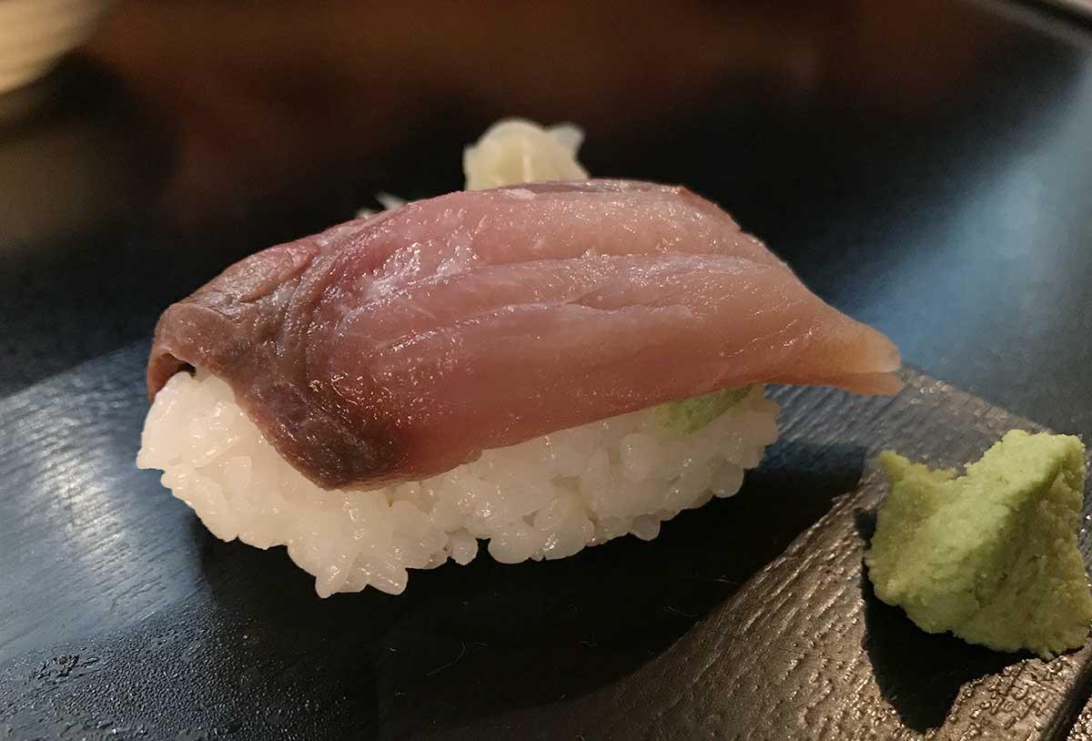 Hamachi sushi of tail meat on a plate. 
				Dennis Schilder. 
				Hamachi shimo nigiri sushi: hamachi  next to tail fin (ハマチしも寿司). 
				
				copyrighted ©. 
				